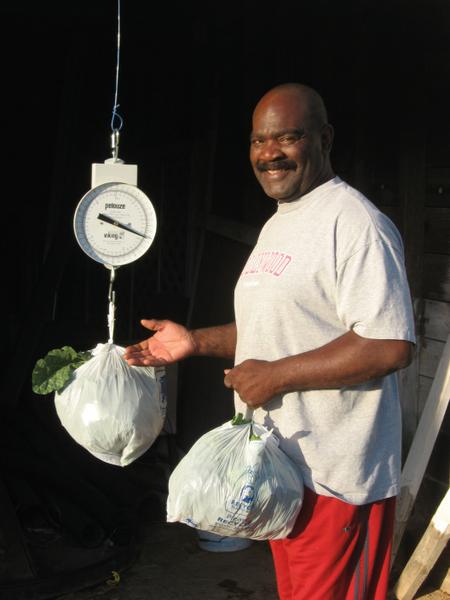 A man weighs bags of produce.
