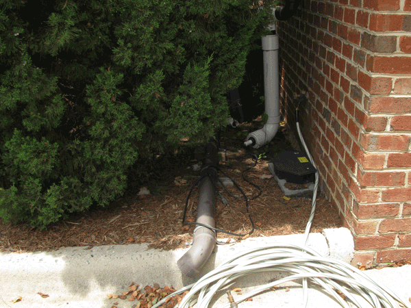 Pipe downspout connected to gutter on the ground