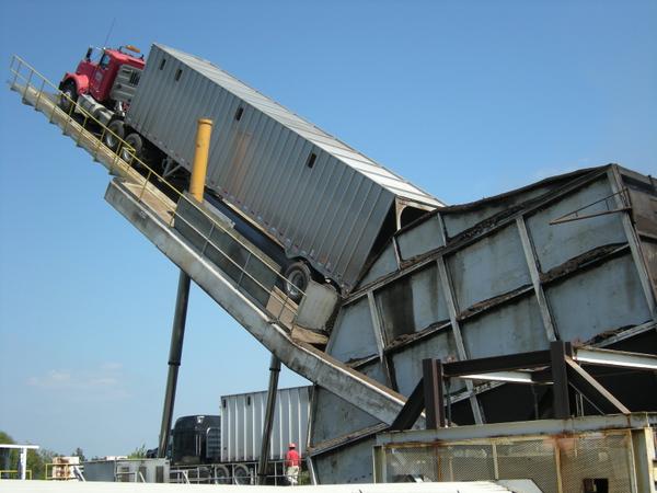 Truck on a hydraulic lift tiled at 45% or more to empty chips.