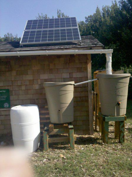Photo of solar cells and rain barrels for water collection