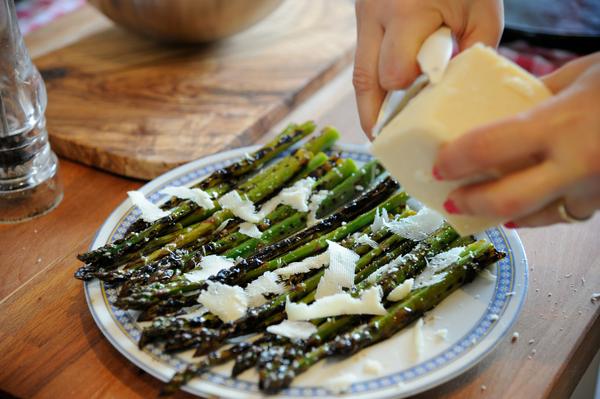 Photo of someone preparing grilled asparagus