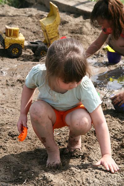 Photo of a child playing in the dirt.