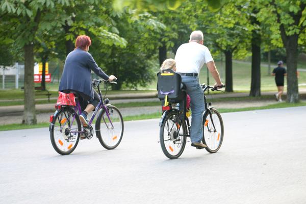 Picture of a man and a woman riding bicycles in a park