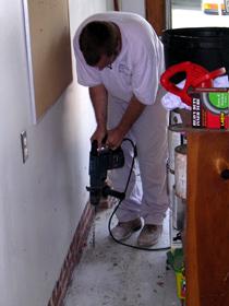 Drilling a garage slab floor to treat for termites