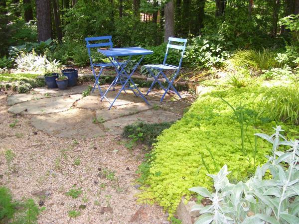 small paved area with small table and two chairs