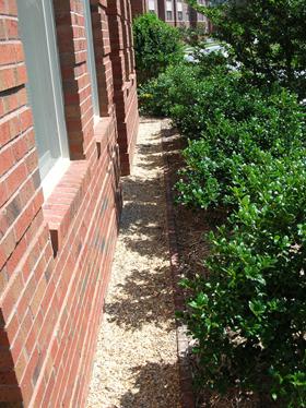 Use a gravel border 6-12" out from foundation walls to
