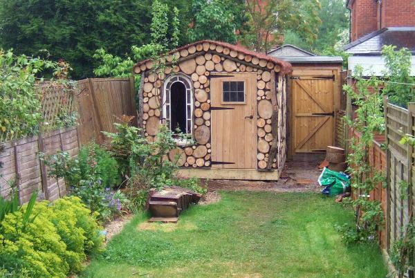 garden shed front decorated with circular wood slices