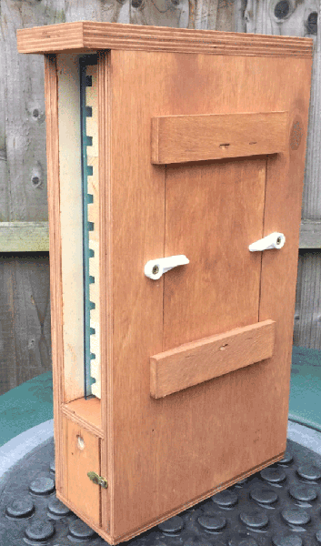 Wooden nest box with a solid panel covering the viewing window.