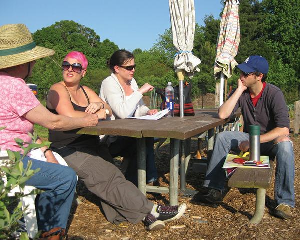 Group of people sit at an outdoor table