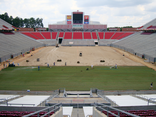 Sod being installed on a football filed.