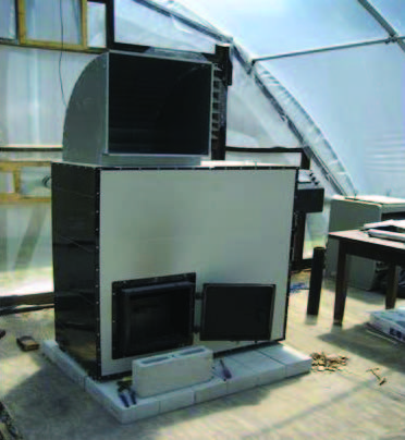 Biomass stove inside hoop house