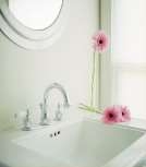 Decorative image of a bathroom faucet on a white sink