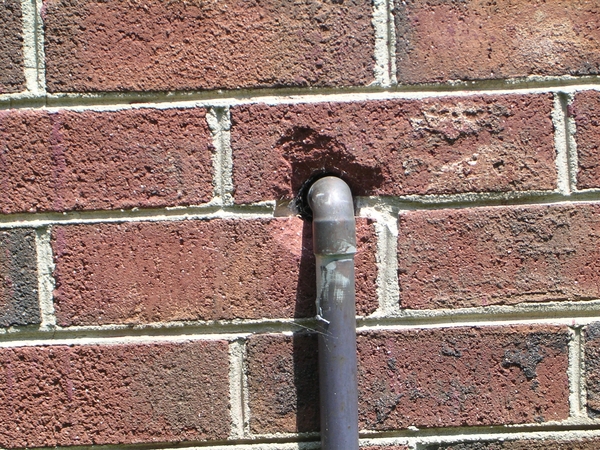 A pipe entering a wall