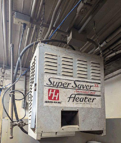A forced air heater installed on the interior of a facility.