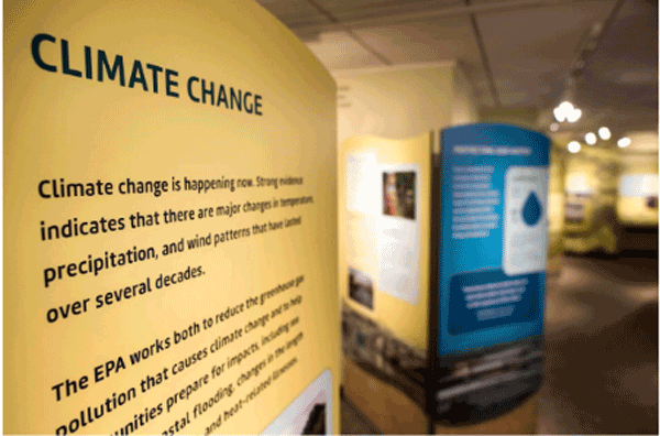 A wall displaying a passage about climate change on it.
