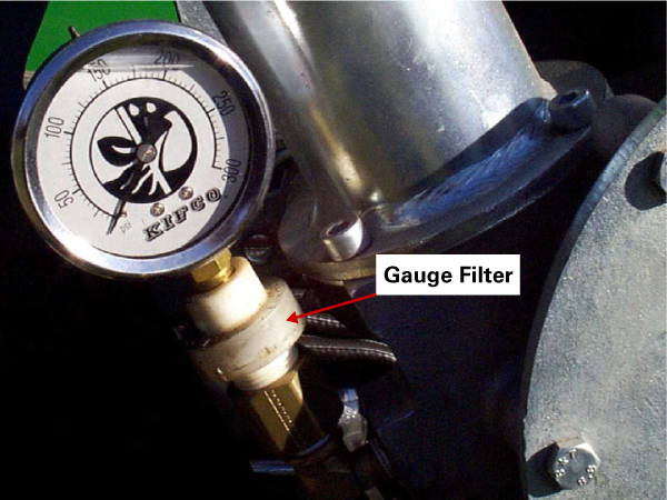 Closeup view of a gauge and with an arrow pointing to the gauge filter.
