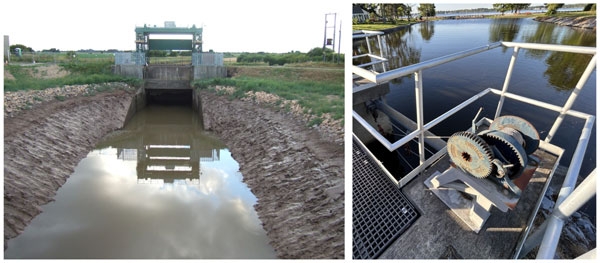 Photos: (l) Closed sluice gate-tidal outfall into River Nene, England. (r) Mechanical winch used to open/close sluice gate. Surrounded on 3 sides by railing & water in background.