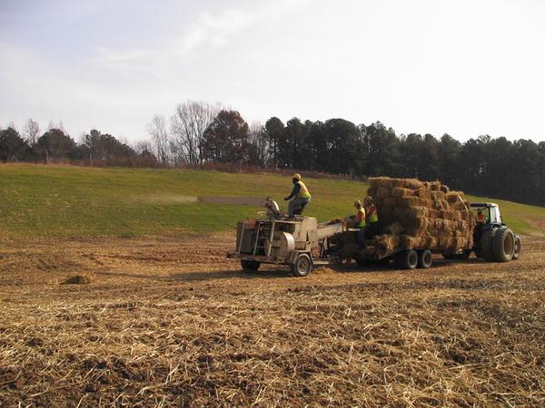 Photo of crew applying straw with a blower