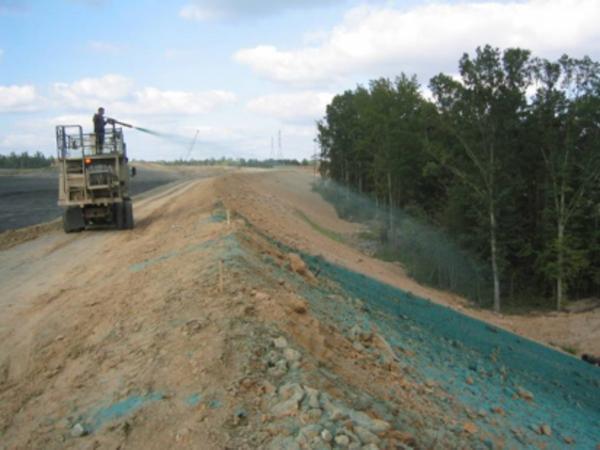 Photo of an operator applying hydromulch to a large slope