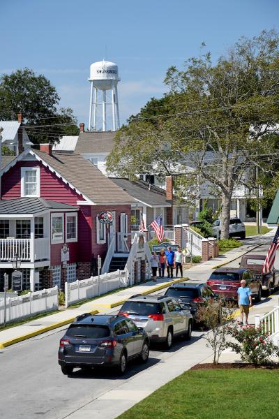Busy street in Swansboro, NC with water tower in background