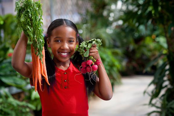 child holding garden harvest
