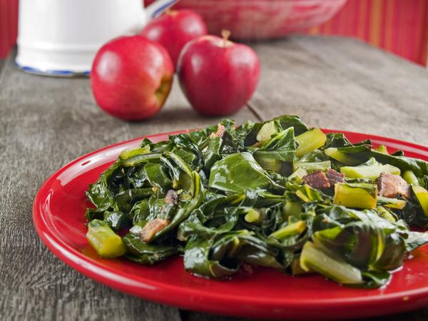 A photo of a dish of collard greens prepared with bacon.