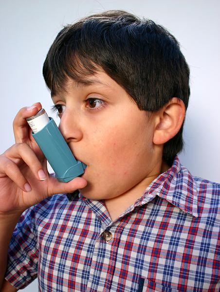 boy using asthma inhaler