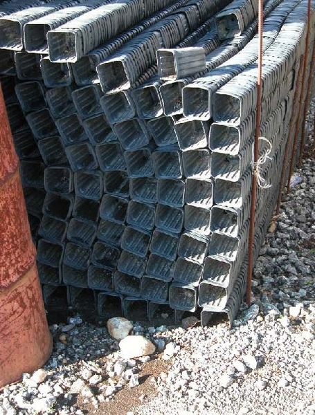 Stacks of small pots layed sideways on ground