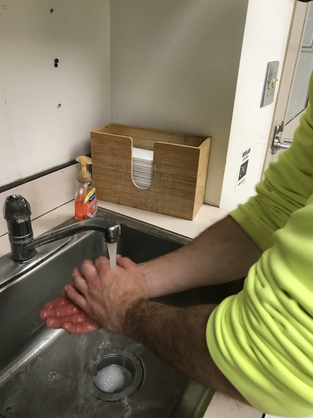 employee of NC State Feed Mill Education Unit washing hands