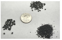 Granulated manure solids with quarter for scale