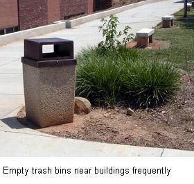 A trash can in a landscaped area